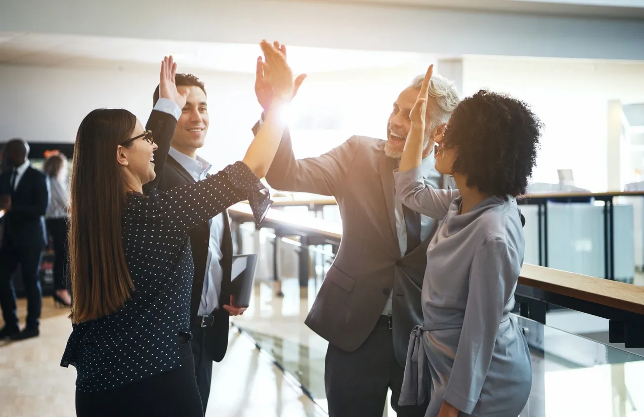 Businesspeople high-fiving